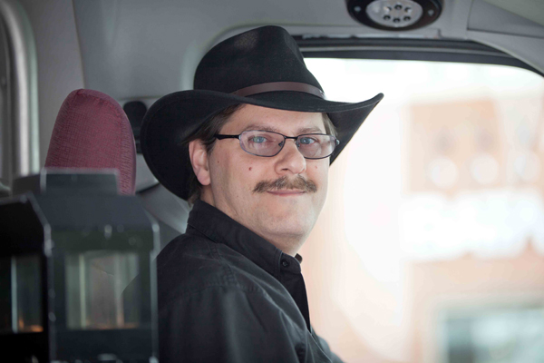 Photograph of Paul in drivers seat of bus